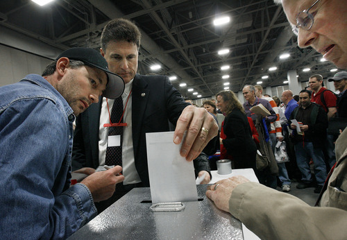 Scott Sommerdorf  |  The Salt Lake Tribune             
Voting monitors at left and right watch as Rep. James Dunnigan, R-Taylorsville, votes during the GOP Convention, Saturday, April 14, 2012. Salt Lake County Republicans gathered to select candidates for county posts.