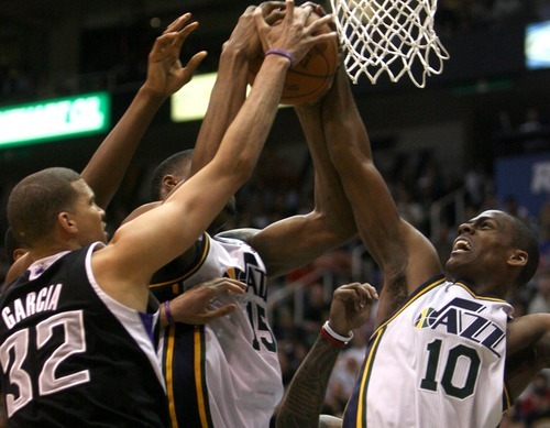 Kim Raff | The Salt Lake Tribune
Jazz players (left) Derrick Favors and Alec Burk battle Kings player Francisco Garcia for a rebound during a game at EnergySolutions Arena in Salt Lake City, Utah on March 30, 2012. The Jazz went on to lose the game 103-104.