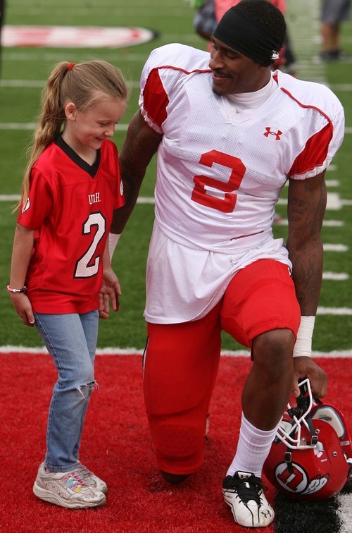 Leah Hogsten  |  The Salt Lake Tribune
Utes wide receiver Kenneth Scott gets his picture taken with a fan. University of Utah football team held their Spring red and white scrimmage Saturday, April 14 2012 in Salt Lake City at Rice Eccles Stadium.