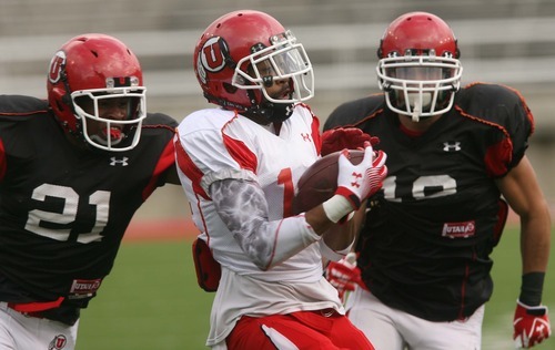 Leah Hogsten  |  The Salt Lake Tribune
Utes wide receiver Reggie Dunn pulls down the pass and is brought down by Tyler White. University of Utah football team held their Spring red and white scrimmage Saturday, April 14 2012 in Salt Lake City at Rice Eccles Stadium.
