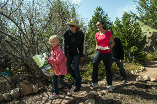 Chris Detrick  |  The Salt Lake Tribune
Lindsay Janicki, right, measures walking distances at Red Butte Garden with Christy and Jeff Porucznik and their kids Quinn, 2, (not pictured) and Zoey, 5,   Friday April 13, 2012. Track-It SLC aims to increase the amount of physical activity children engage in by providing caregivers with diverse walking routes and associated distances for recreational attractions throughout Salt Lake.