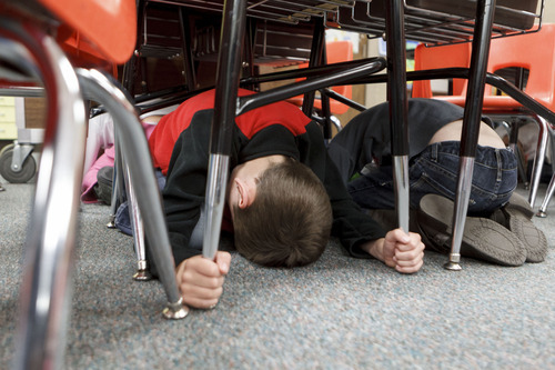 Trent Nelson  |  The Salt Lake Tribune
First graders at Granite Elementary duck and cover under their desks during a statewide earthquake drill Tuesday, April 17, 2012 in Sandy, Utah.