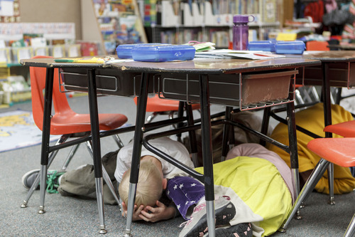 Trent Nelson  |  The Salt Lake Tribune
First graders at Granite Elementary duck and cover under their desks during a statewide earthquake drill Tuesday, April 17, 2012 in Sandy, Utah.