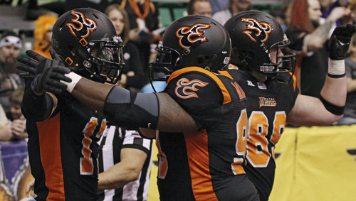 Lennie Mahler  |  The Salt Lake Tribune
Utah Blaze players celebrate a touchdown in the first half against the San Jose SaberCats at EnergySolutions Arena on Saturday, March 24, 2012.