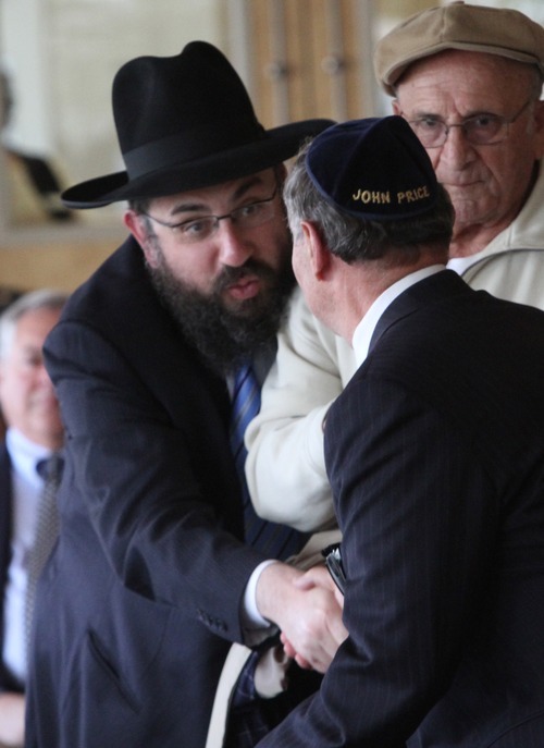 Rick Egan  | The Salt Lake Tribune 

John Price shakes hands with Rabbi Benny Zippel after giving a speech at the Jewish Community Center, Thursday, April 19, 2012.  Price's family escaped Germany, after experiencing the horrors of Kristallnacht, with the help of Herr Trautschold, a non-Jew who managed to get the Price family passports and visas for Panama.