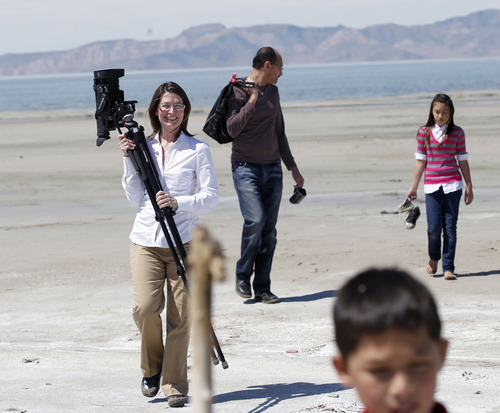 Al Hartmann  |  The Salt Lake Tribune
Shirley Erickson Gorospe has made a documentary about a state plan to lease thousands of acres of the Great Salt Lake to a mineral company that plans to build a series of dikes to help harvest minerals. Gorospe wants to stop the project and spent her own money to make the documentary she released on YouTube.  She films as her husband Archie plays with her children Emily and Eric near Saltair on Monday April 16.