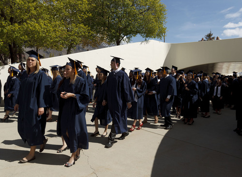 Trent Nelson  |  The Salt Lake Tribune
Graduates walk to the Marriott Center in the processional at BYU's Spring Commencement Exercises on Thursday.