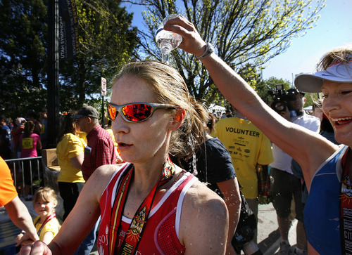 Scott Sommerdorf  |  The Salt Lake Tribune             
Women's winner Devra Viercante has water poured on her by her friend Emily Bates, after Viercante was the first woman across the finish line with a time of 2:54.56 at the Salt Lake City Marathon, Saturday, April 21, 2012.