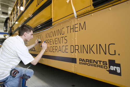 Paul Fraughton | The Salt Lake Tribune.
Daniel Johnson, of Wrap Star, puts  the finishing touches on an ad placed on a Jordan District school bus. The district had the ad  put on four of their buses  with plans to do more.  Money generated from the ads  will stay in the transportation dept.The district will review all advertising, making sure it complies  with guidelines  they established.
 Tuesday, April 24, 2012