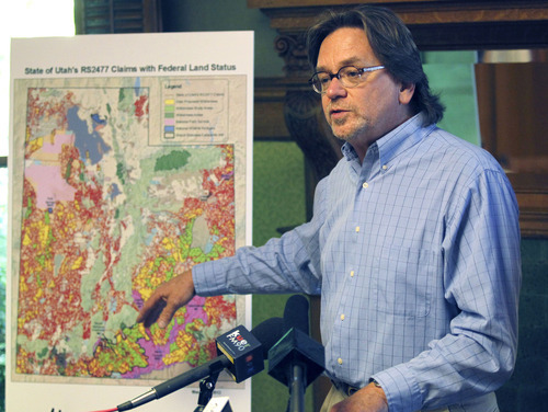 Al Hartmann  |  The Salt Lake Tribune
Tim Wagner, organizing representative, Resilient Habits Campaign for Sierra Club, speaks at a news conference Tuesday, April 24, about the state of Utah's claim to thousands of dirt roads throughout the state.    The map at left shows a red maze of over 25,000 highway rights of way sought by the state of Utah.   SUWA and other conservation and recreation groups contend the case is about wilderness, not transportation.