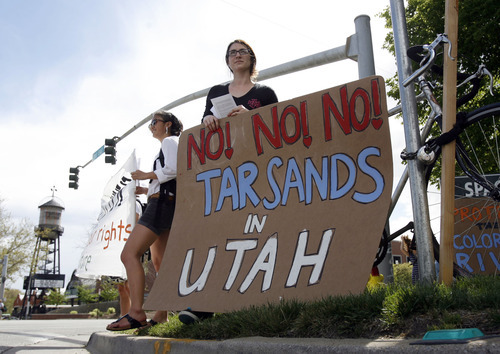 Francisco Kjolseth  |  The Salt Lake Tribune
Peaceful Uprising partners with Utah Tar Sands Resistance for a demonstration at the School and Institutional Trust Lands Administration (SITLA) office on Monday, April 23, 2012, as Sara Ma, left, and Sierra Hattier join the demonstration.