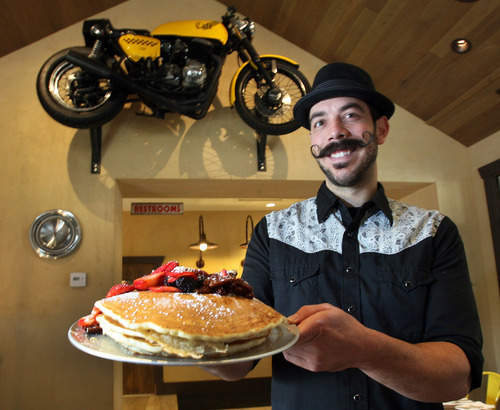 Steve Griffin | The Salt Lake Tribune
Herm's Inn manager Ryan Bird holds an order of pancakes. The new Logan restaurant in a historic building has a menu that includes pancakes, omelets, breakfast skillets, hamburgers and sandwiches.