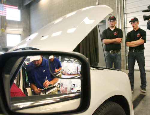 Steve Griffin  |  The Salt Lake Tribune
Riverton High School students Jordan Kearns and Chandler Adkins stand next to a Ford Fusion as their work is judged during the Ford/AAA Student Auto Skills Competition at the Salt Lake Community College MIller Campus in Sandy on Thursday April 26, 2012. Twenty junior and senior high school students competed in the event, which tests students' technician skills. Each team received an identical Ford Fusion that had nine 