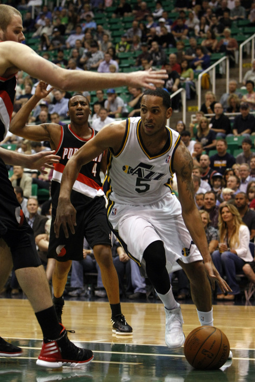 Chris Detrick  |  The Salt Lake Tribune
Utah Jazz point guard Devin Harris (5) runs around Portland Trail Blazers center Joel Przybilla (10) during the first quarter of the game at EnergySolutions Arena Thursday April 26, 2012. The Jazz are winning the game 23-16.