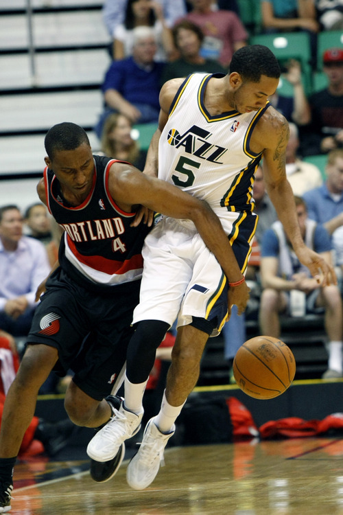 Chris Detrick  |  The Salt Lake Tribune
Utah Jazz point guard Devin Harris (5) and Portland Trail Blazers guard Nolan Smith (4) go for the ball during the first quarter of the game at EnergySolutions Arena Thursday April 26, 2012. The Jazz are winning the game 23-16.