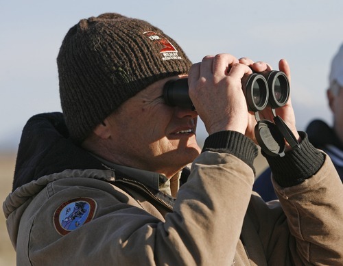 Rick Egan  | The Salt Lake Tribune 

Utah DWR biologist Guy Wallace observes the Gunnison sage grouse at sunrise as they strut on a lek near Monticello, Utah, March 31, 2012.
