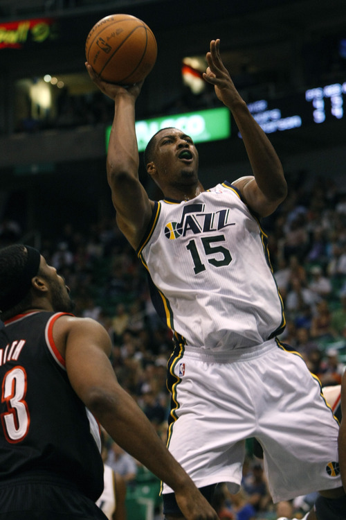 Chris Detrick  |  The Salt Lake Tribune
Utah Jazz forward/center Derrick Favors (15) shoots past Portland Trail Blazers power forward Craig Smith (83) during the first quarter of the game at EnergySolutions Arena Thursday April 26, 2012. The Jazz are winning the game 23-16.