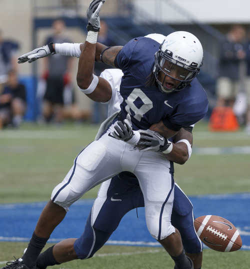 Trent Nelson  |  The Salt Lake Tribune
Cornerback Nevin Lawson, rear, knocks the ball away from receiver Travis Reynolds at Utah State's annual Blue and White football game Saturday, April 28, 2012 in Logan, Utah.
