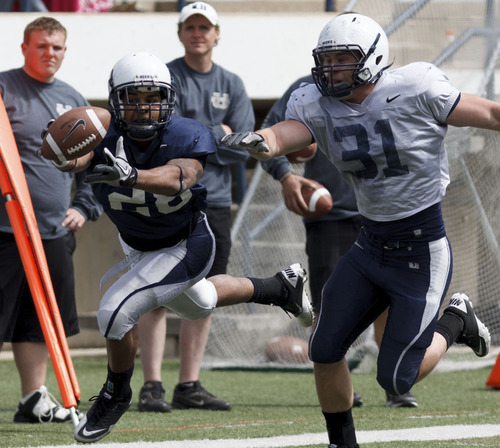 Trent Nelson  |  The Salt Lake Tribune
Running back Joey DeMartino stretches out for the ball but comes up short at Utah State's annual Blue and White football game Saturday, April 28, 2012 in Logan, Utah. Defending is Parker Hausknecht