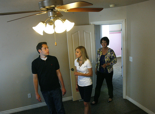 Scott Sommerdorf  |  The Salt Lake Tribune             
Realtor Donna Pozzuoli, right, shows Chace and Madison Larsen a property in Herriman, Sunday April 22, 2012. The Larsens are buying this home at a time when the market is slowly improving.