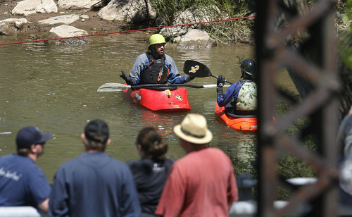 Scott Sommerdorf  |  The Salt Lake Tribune             
Search and rescue personnel search for a missing 3-year-old boy in the Weber River just north of Exchange Road in Ogden, Sunday, April 29, 2012, while civilians - presumably family members - watch from a nearby bridge.