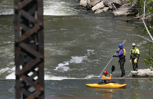Scott Sommerdorf  |  The Salt Lake Tribune             
A search and rescue worker uses a long probe to search for a missing 3-year-old boy in the Weber River just north of Exchange Road in Ogden, Sunday, April 29, 2012.