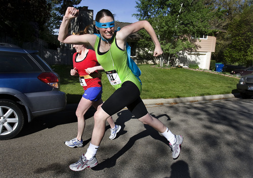 Scott Sommerdorf  |  The Salt Lake Tribune             
Friends Jessica Cope, foreground, and Mariah Fenn run the Shriners Hospital for Children 5K and 10K fundraiser dressed up in superhero gear on Saturday in Provo. The run helped raise money for children born with orthopaedic and neuromusculoskeletal disorders. The event's grand marshal was Bridger Housley, a 15-month-old born with Larsen's syndrome, a rare connective tissue disorder.