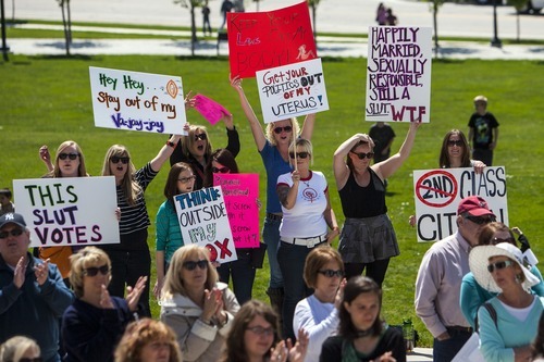 Chris Detrick  |  The Salt Lake Tribune
Participants hold up signs during a Unite Against the War on Women rally at the Utah State Capitol on Saturday.