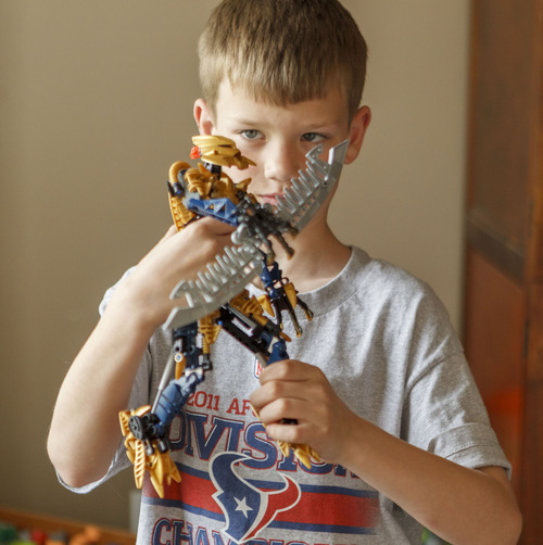 Trent Nelson  |  The Salt Lake Tribune
Jack Wolfinger poses with one of his favorite toys, a Bioncle figure that he assembled, Thursday, April 26, 2012 in Ogden, Utah. After the CDC released new data on autism a few weeks ago, some experts are questioning the results. Jack was repeatedly labeled by teachers as possibly autistic, but last year a Utah psychologist said the symptoms were there but the diagnosis did not entirely fit.