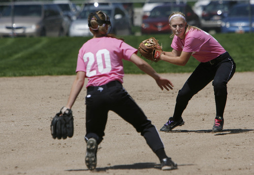 Francisco Kjolseth  |  The Salt Lake Tribune
Pleasant Grove's Calli Clark, right, looks for an out as Sarah Hicken looks on as softball players from a number of schools took each other on at the Big Cottonwood Regional Park compex as part of Swing for Life, which raises money for breast cancer research.