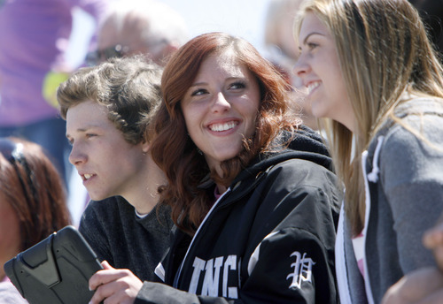 Francisco Kjolseth  |  The Salt Lake Tribune
Jade Kennedy, 18, center, a former softball player with Pleasant Grove, keeps an eye on the game as an assistant coach alongside her boyfriend, Brett Stewart, 18, and best friend Stephanie Harris, 18. In support of her recent diagnosis with thyroid cancer, all of the players wore her former #20 as softball players from a number of schools took each other on at the Big Cottonwood Regional Park compex on Saturday, April 28, 2012, as part of Swing for Life, which raises money for breast cancer research.