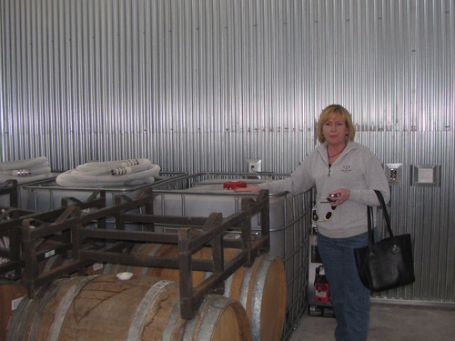 Mark Havnes | The Salt Lake Tribune
Laura McBride, operations manager of the new Iron Gate Winery in Cedar City, stands next to casks and vats of wine already produced elsewhere and brought to the winery's production area where they will eventually be blended into the winery's signature wine.