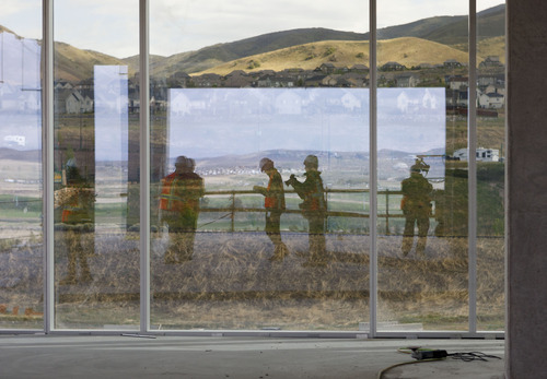 Trent Nelson  |  The Salt Lake Tribune
Photographers reflected in a window during a tour of the construction of the first phase of Adobe's new campus Tuesday, May 1, 2012 in Lehi, Utah. The 280,000 square-foot building is set to be completed in late 2012.