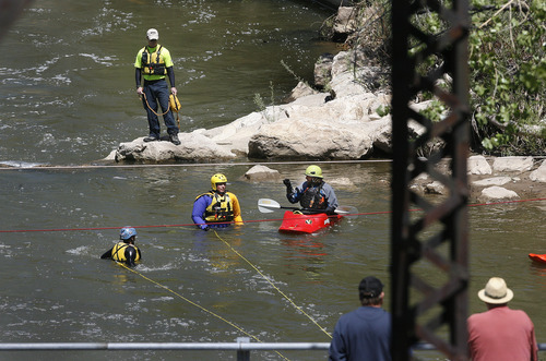 Scott Sommerdorf  |  The Salt Lake Tribune             
Search and rescue personnel search for a missing 3-year-old boy in the Weber River just north of Exchange Road in Ogden, Sunday, April 29, 2012.
