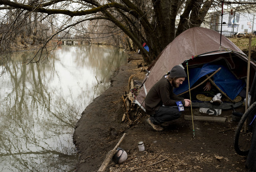 Trent Nelson  |  The Salt Lake Tribune
Buddy Tymczyszyn, of Volunteers of America, speaks to a man in a homeless camp along the Jordan River while working on Utah's annual statewide Point-in-Time homeless count in Salt Lake City on Thursday, Jan. 26, 2012.