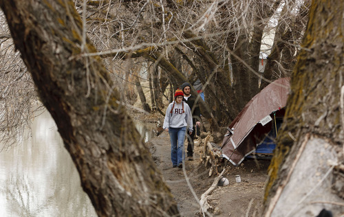 Trent Nelson  |  The Salt Lake Tribune
Kimberly Bell and Buddy Tymczyszyn, of Volunteers of America, make their way through a homeless camp along the Jordan River while working on Utah's annual statewide Point-in-Time homeless count in Salt Lake City on Thursday, Jan. 26, 2012.