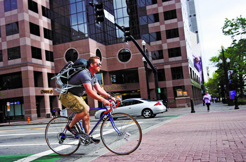 Kim Raff | The Salt Lake Tribune
A person rides a bicycle down 200 South in downtown Salt Lake City, Utah on April 30, 2012.