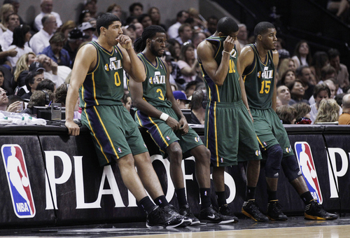 Utah Jazz's Enes Kanter (0), DeMarre Carroll (3), Alec Burks (10) and Derrick Favors (15) wait on the sideline during a timeout in the fourth quarter of Game 2 of a first-round NBA basketball playoff series against the San Antonio Spurs, Wednesday, May 2, 2012, in San Antonio. San Antonio won 114-83. (AP Photo/Eric Gay)