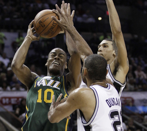 Utah Jazz's Alec Burks (10) works against San Antonio Spurs' Tim Duncan, center, and Danny Green during the first quarter of Game 2 of a first-round NBA basketball playoff series, Wednesday, May 2, 2012, in San Antonio. (AP Photo/Eric Gay)