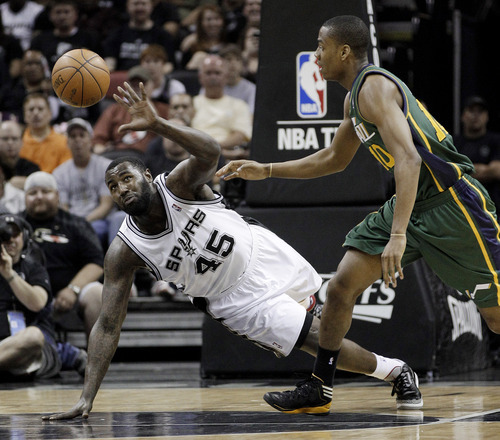 San Antonio Spurs' DeJuan Blair (45) and Utah Jazz's Alec Burks, right, chase a loose ball during the second quarter of Game 2 of a first-round NBA basketball playoff series, Wednesday, May 2, 2012, in San Antonio. (AP Photo/Eric Gay)