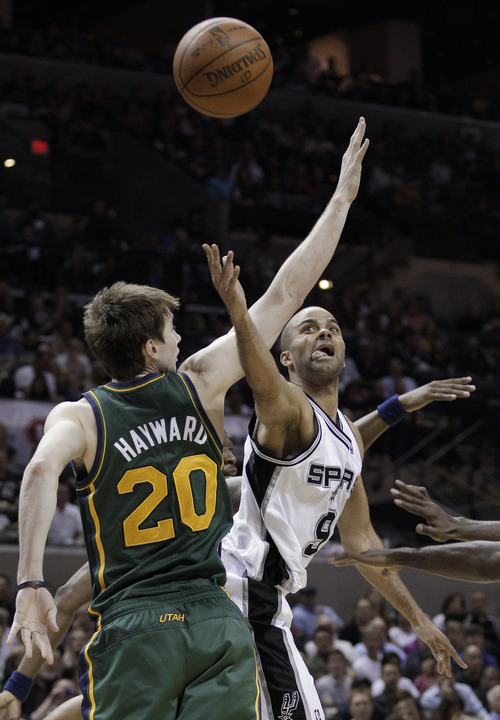 San Antonio Spurs' Tony Parker, right, shoots against Utah Jazz's Gordon Hayward (20) during the third quarter of Game 2 of a first-round NBA basketball playoff series, Wednesday, May 2, 2012, in San Antonio. (AP Photo/Eric Gay)