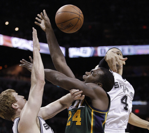 Utah Jazz's Paul Millsap (24) works between San Antonio Spurs' Matt Bonner, left, and Danny Green during the second quarter of Game 2 of a first-round NBA basketball playoff series, Wednesday, May 2, 2012, in San Antonio. (AP Photo/Eric Gay)