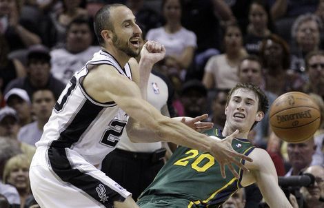 San Antonio Spurs' Manu Ginobili, left, of Argentina, and Utah Jazz's Gordon Hayward (20) reach for a loose ball during the second quarter of Game 2 of a first-round NBA basketball playoff series, Wednesday, May 2, 2012, in San Antonio. (AP Photo/Eric Gay)