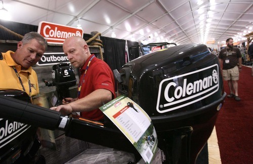 Leah Hogsten  |  The Salt Lake Tribune
Coleman Outboard Motors retailer Neil Godfrey (center, in red) said that although his booth is located in the expansion tent at the Outdoor Retailer show, foot traffic and the number of interested retailers has not suffered. The Outdoor Retailer Summer Market has outgrown the Calvin L. Rampton Salt Palace Convention Center. Now, an estimated 200 retailers are showing their wares outside in a tent.  Thursday, August 4 2011 in Salt Lake City.