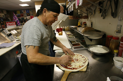 Scott Sommerdorf  |  The Salt Lake Tribune             
Chef and owner John Martin makes a cheese pizza at Pop On Over Cafe in South Jordan.