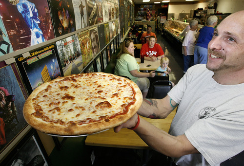 Scott Sommerdorf  |  The Salt Lake Tribune             
Waiter Mike Treder holds a freshly-made cheese pizza at Pop On Over Cafe in South Jordan on April 23, 2012.