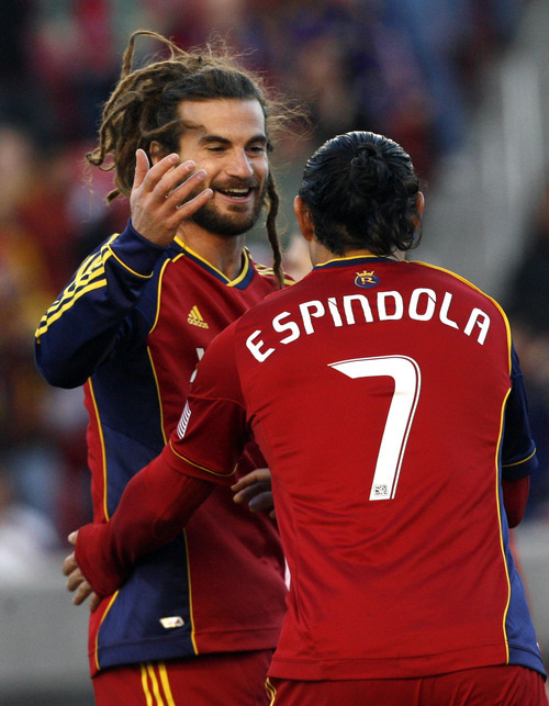Real Salt Lake's Kyle Beckerman (5) celebrates with Fabian Espindola (7) after scoring against Toronto FC during their MLS soccer match, Saturday, April 28, 2012, in Salt Lake City. Real Salt Lake won 3-2. (AP Photo/The Salt Lake Tribune, Rick Egan)  DESERET NEWS OUT; LOCAL TV OUT; MAGS OUT
