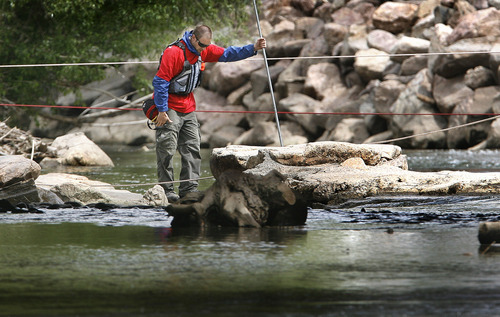 Scott Sommerdorf  |  Tribune file photo             
A search and rescue worker pauses while searching an area near the Exchange Street bridge in Ogden on Monday.