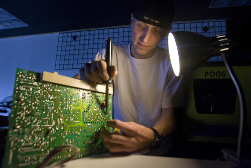 Paul Fraughton  |  The Salt Lake Tribune
Chris Wright works on one of the machines at Atomic Arcade in Holladay. Many of the arcade games that Wright offers need repairs.