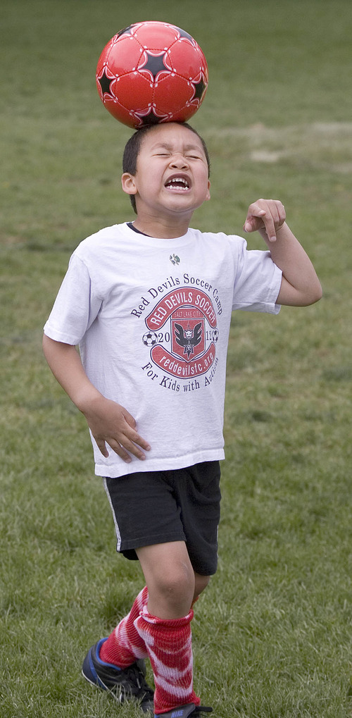 Paul Fraughton | The Salt Lake Tribune
Charlie Cunningham practices heading the ball, Charlie joined other kids with autism at a soccer clinic run by the RedDevils Soccer Club at the Carmen B. Pingree School and Sunnyside Park in Salt Lake City. 
 Thursday, May 3, 2012